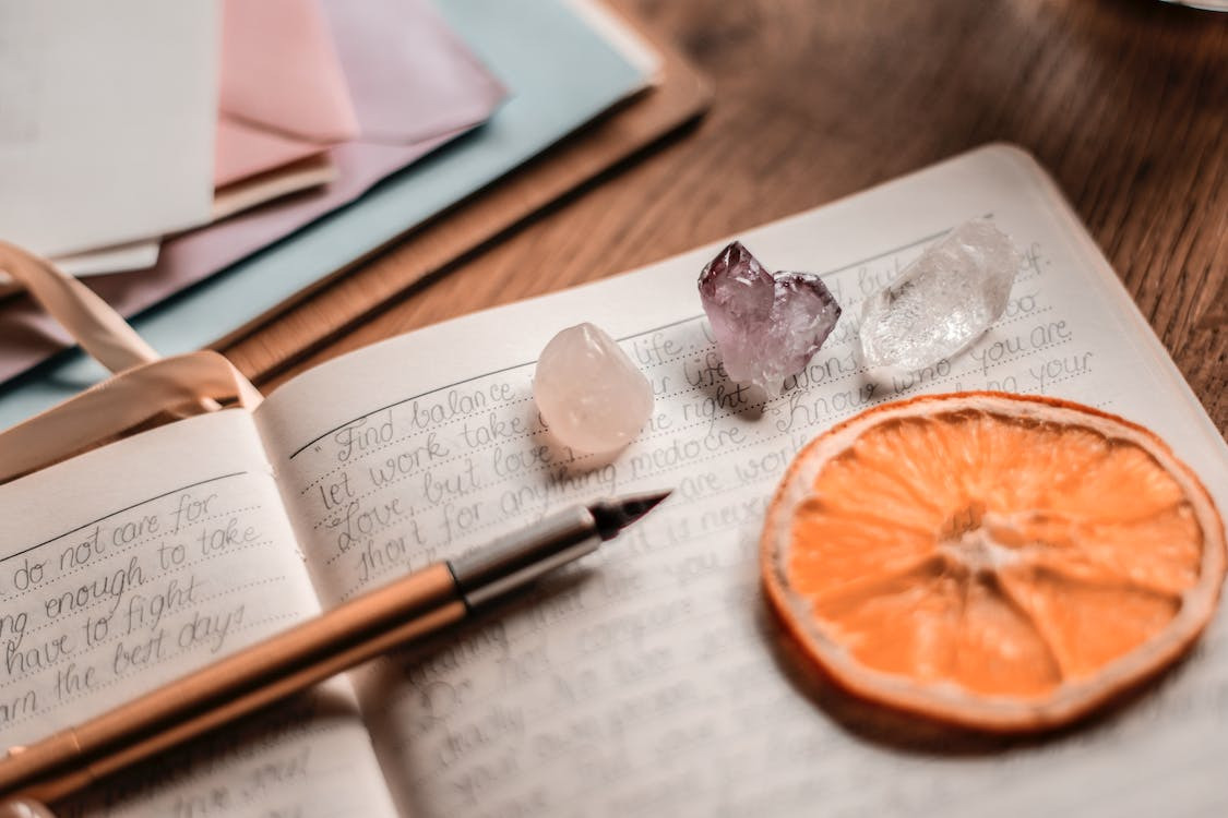 A serene workspace with a journal open to a page filled with reflective prompts, symbolizing the journey of personal growth and self-discovery through writing.