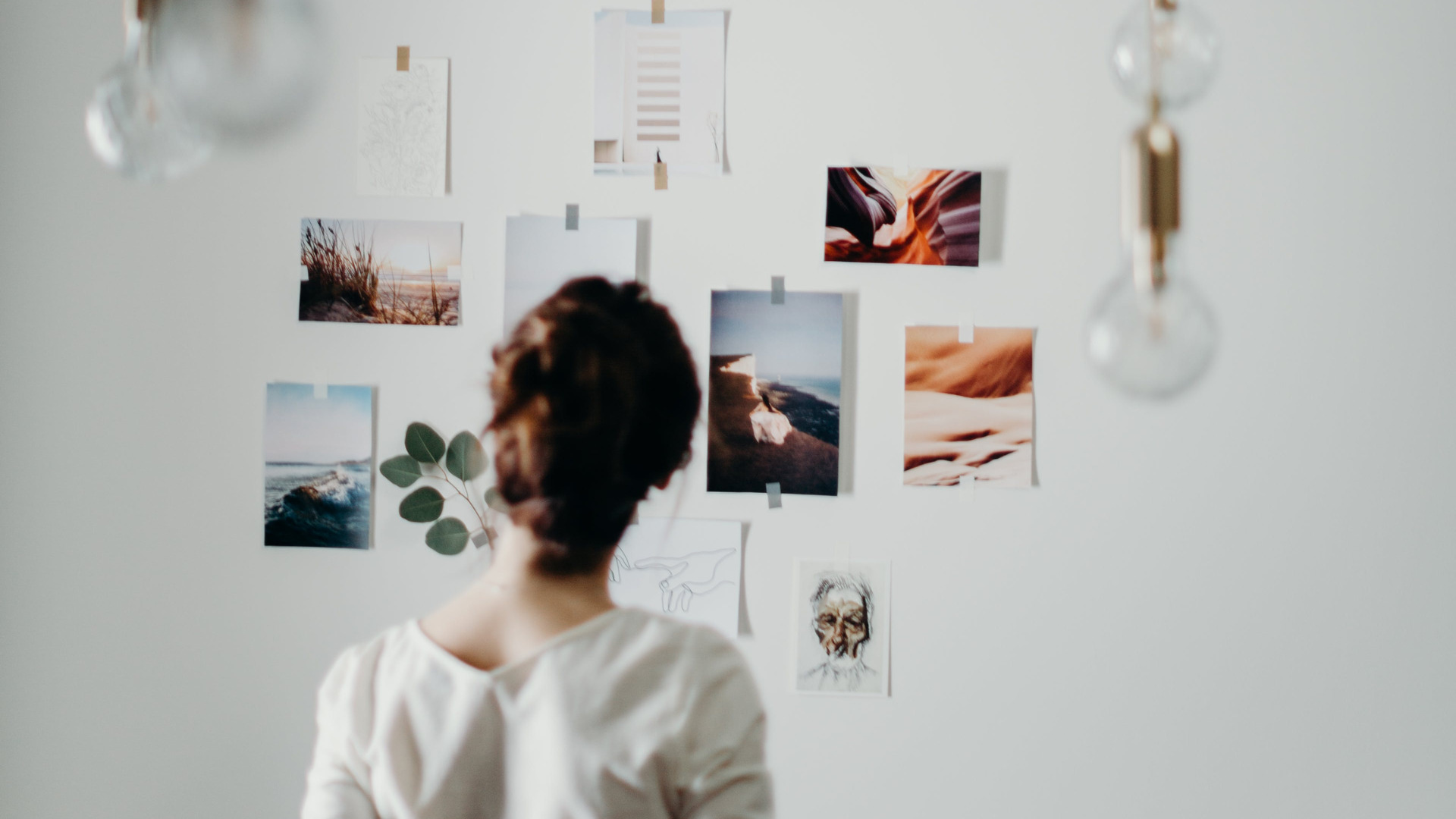 a woman creating a vision board filled with goals, dreams, and aspirations