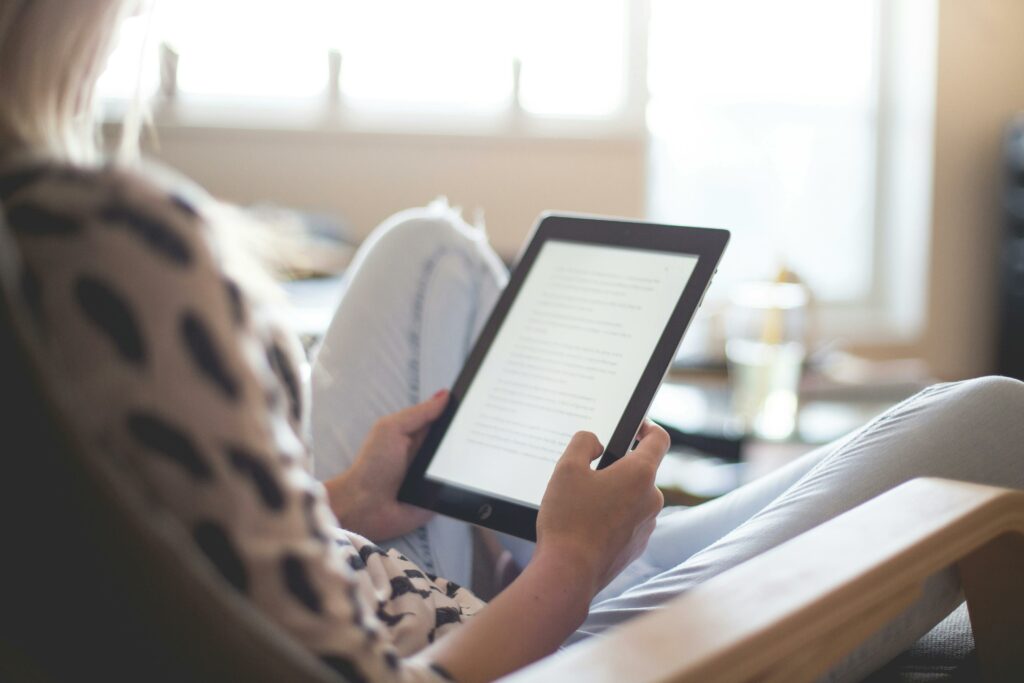 woman reading on a device representing the benefits of learning for personal growth