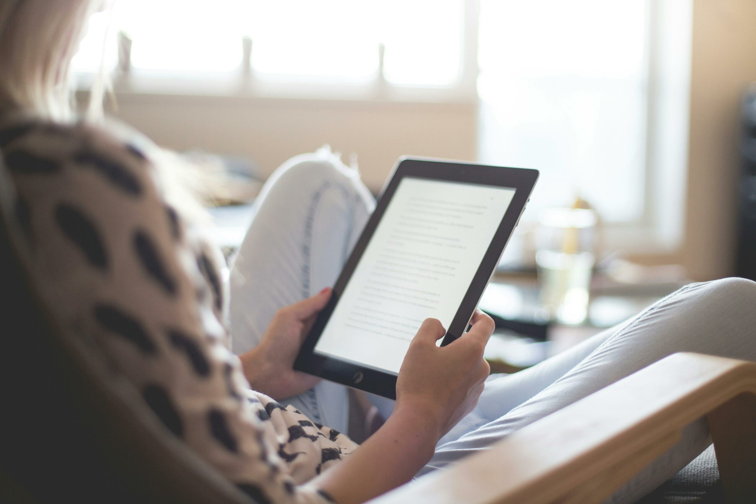 woman reading on a device representing the benefits of learning for your brain and career