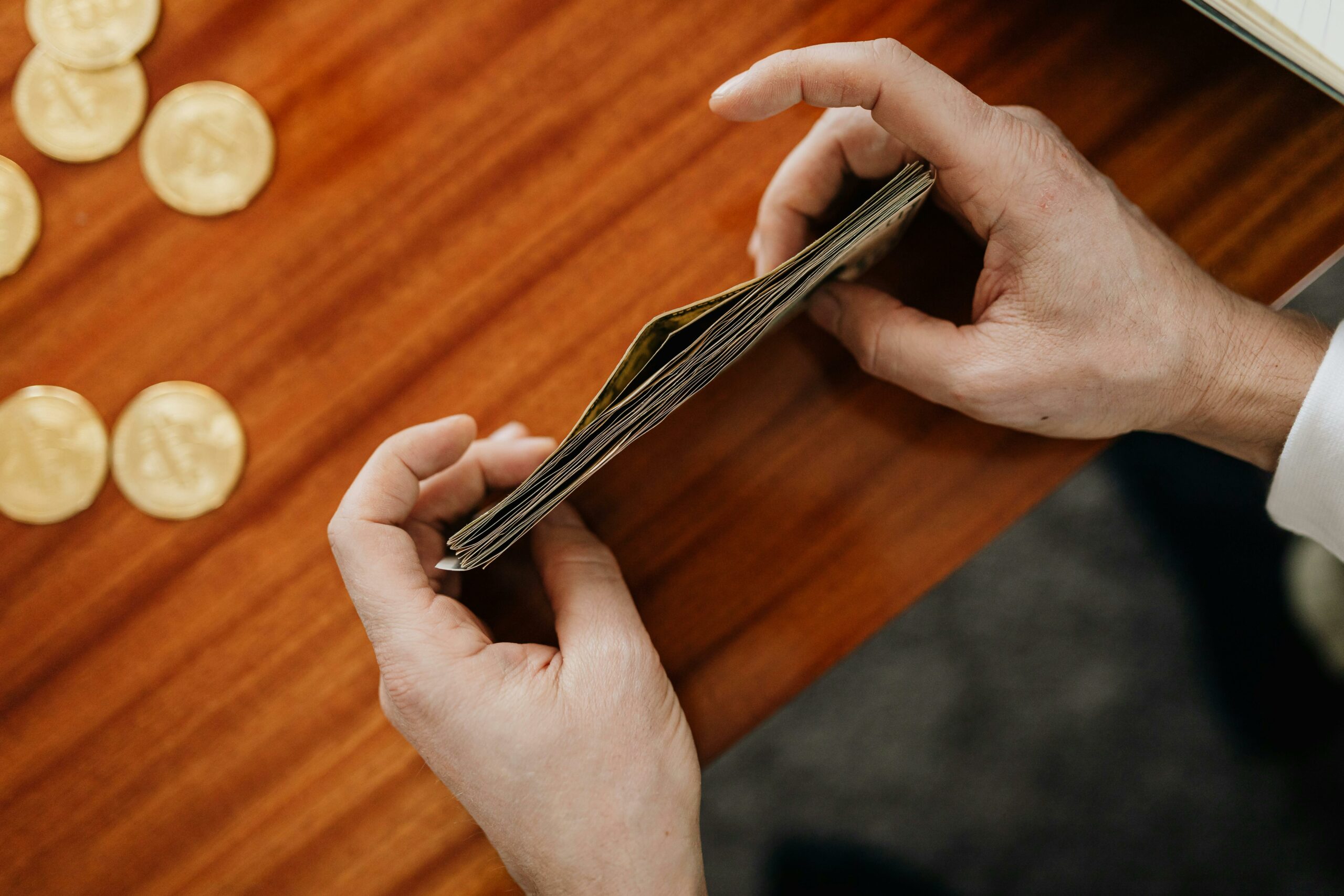 person counting money and cutting expenses.