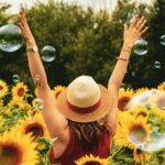 woman in a sunflower field representing how to find happiness within