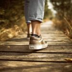 feet of a person walking representing the benefits of walking