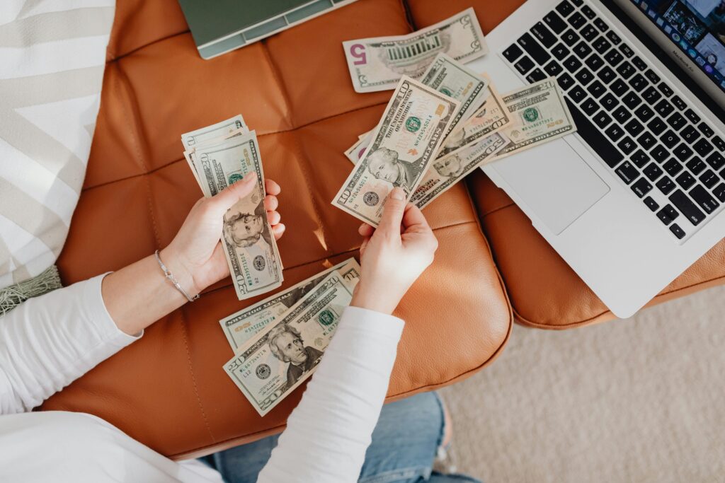 person counting money reflecting how to save for an emergency fund