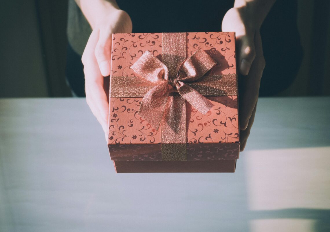 someone holding a gift representing a gift selected from some gift ideas