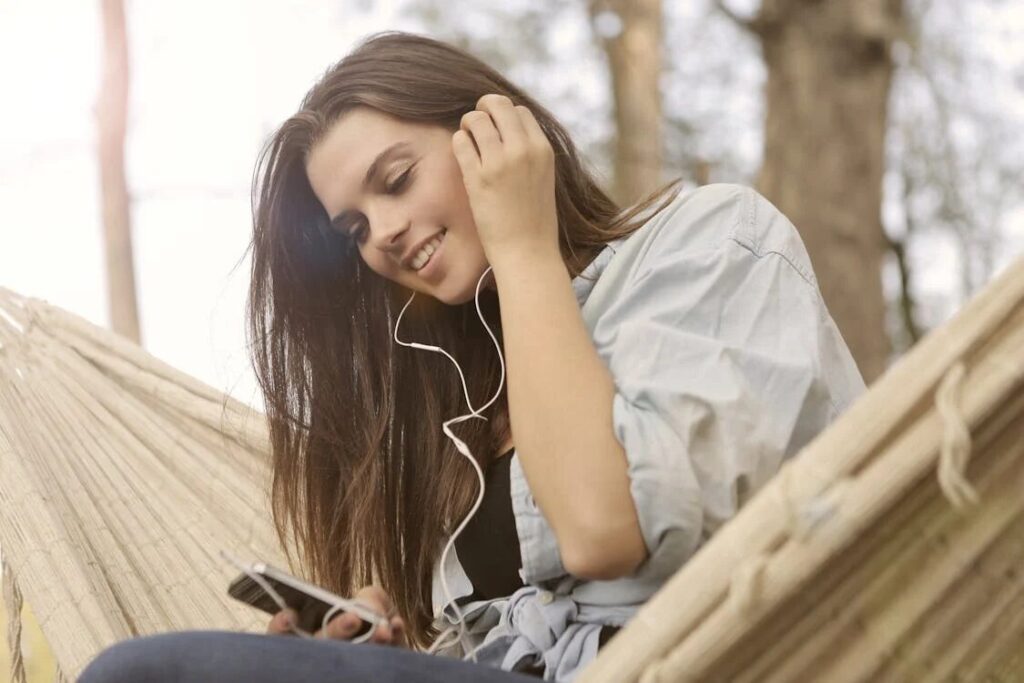 woman listening to a tranquil meditation music artist list